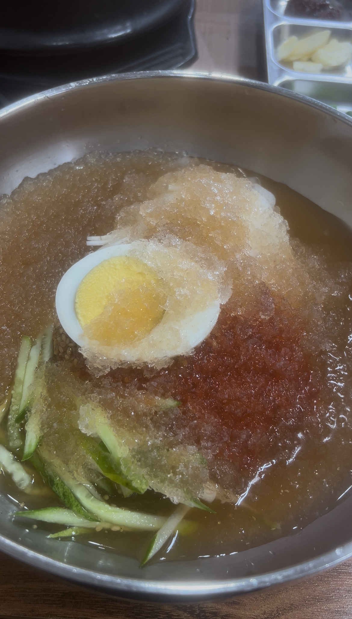 A full bowl of Eolchigi-naengmyeon cold noodles.