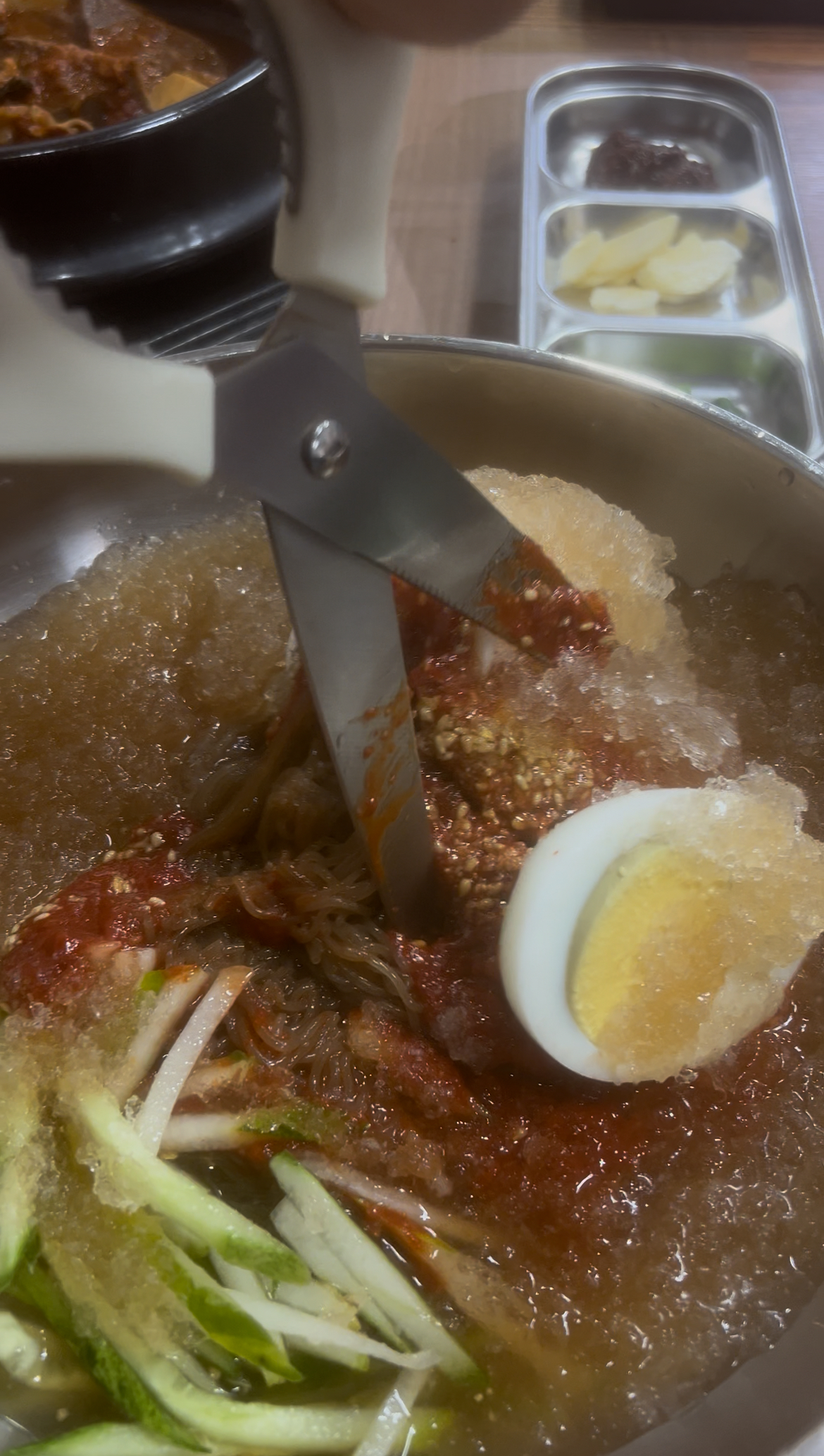 A close-up of the chewy noodles coated in the spicy sauce.
