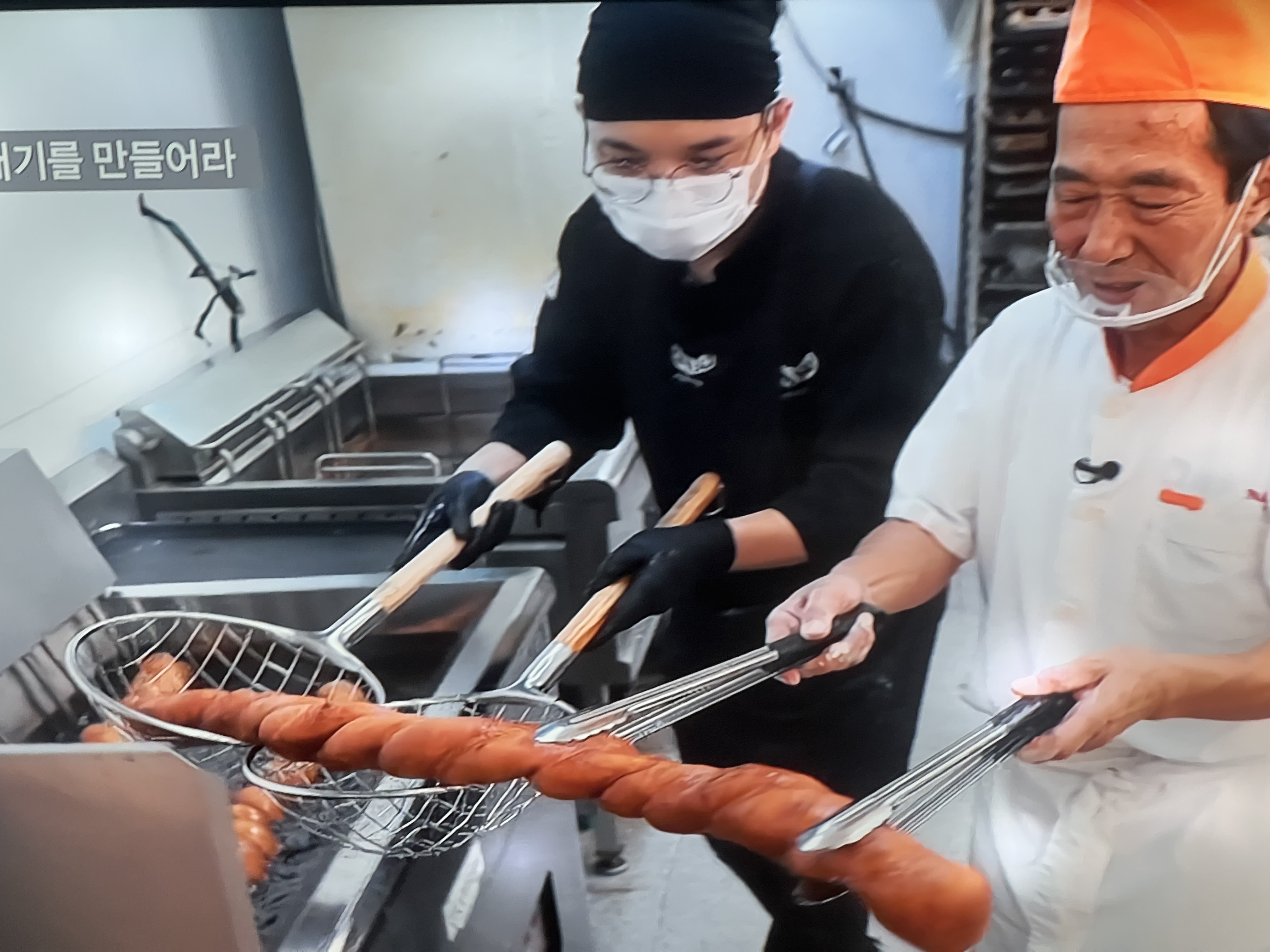Freshly fried Kkwabaegi Korean donuts cooling - golden brown Korean twisted pastry