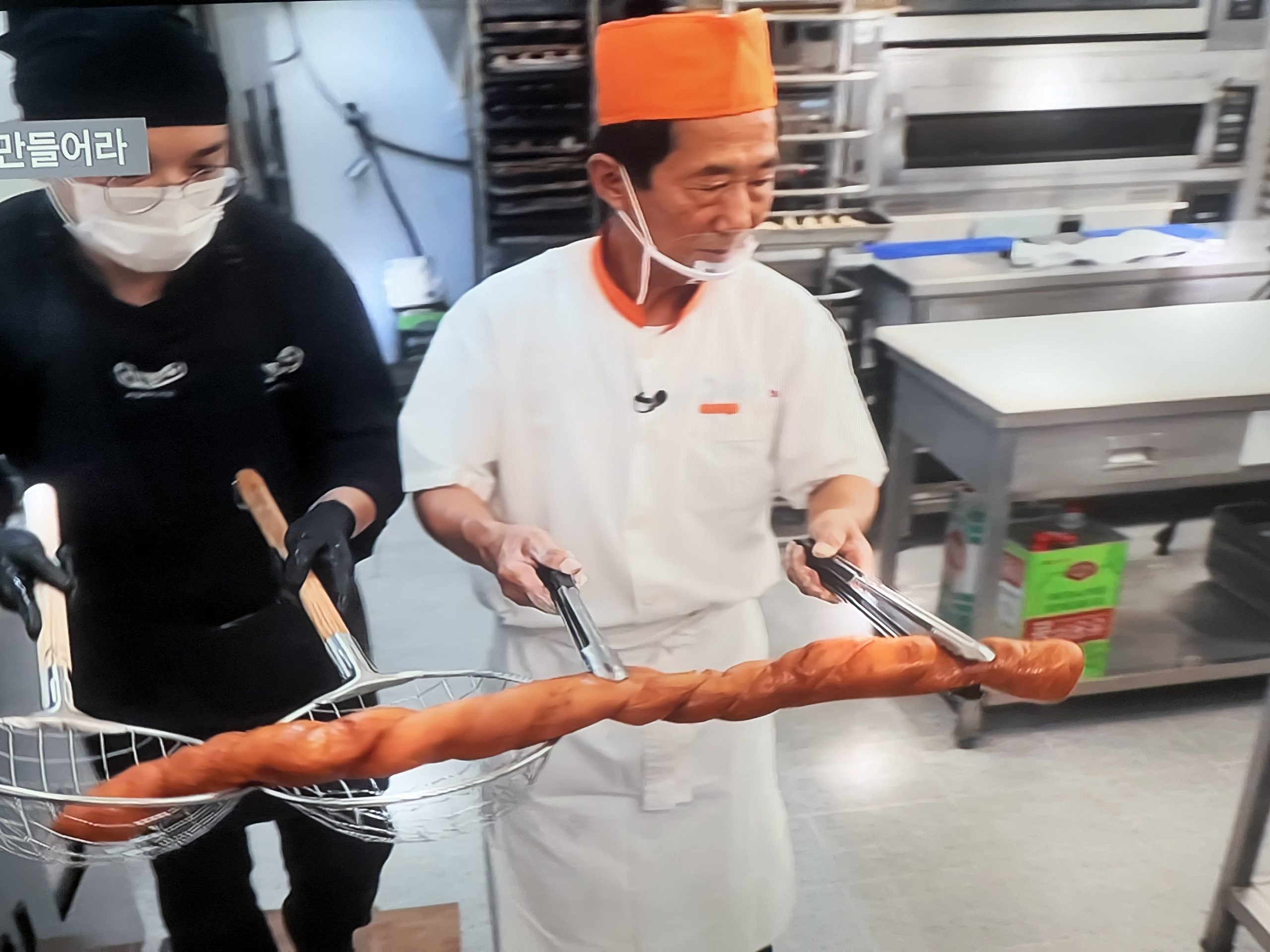Coating Kkwabaegi Korean donuts in sugar - final step of Korean donut preparation
