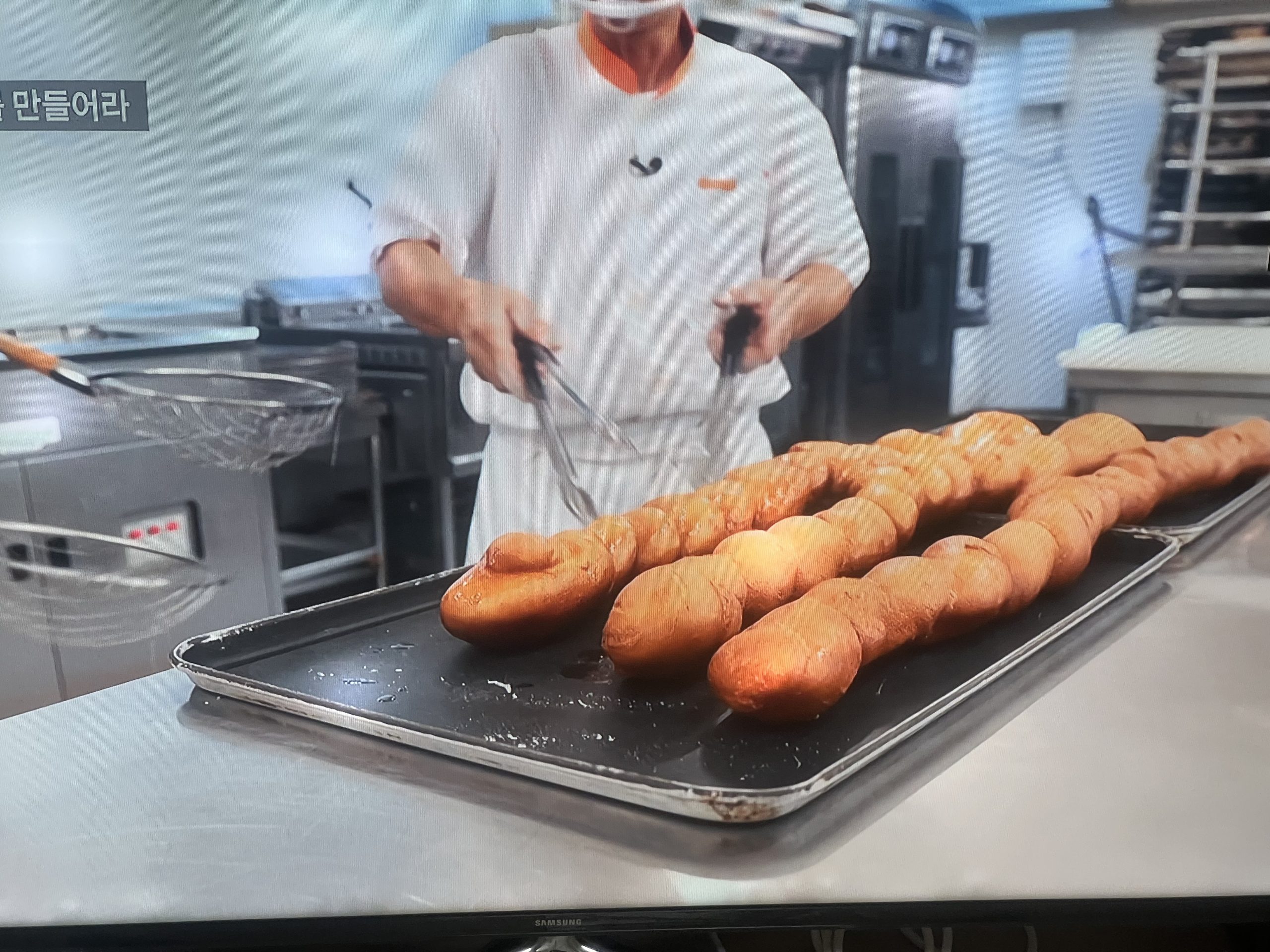 Tray of freshly made Kkwabaegi Korean donuts ready to eat - traditional Korean twisted pastry perfection